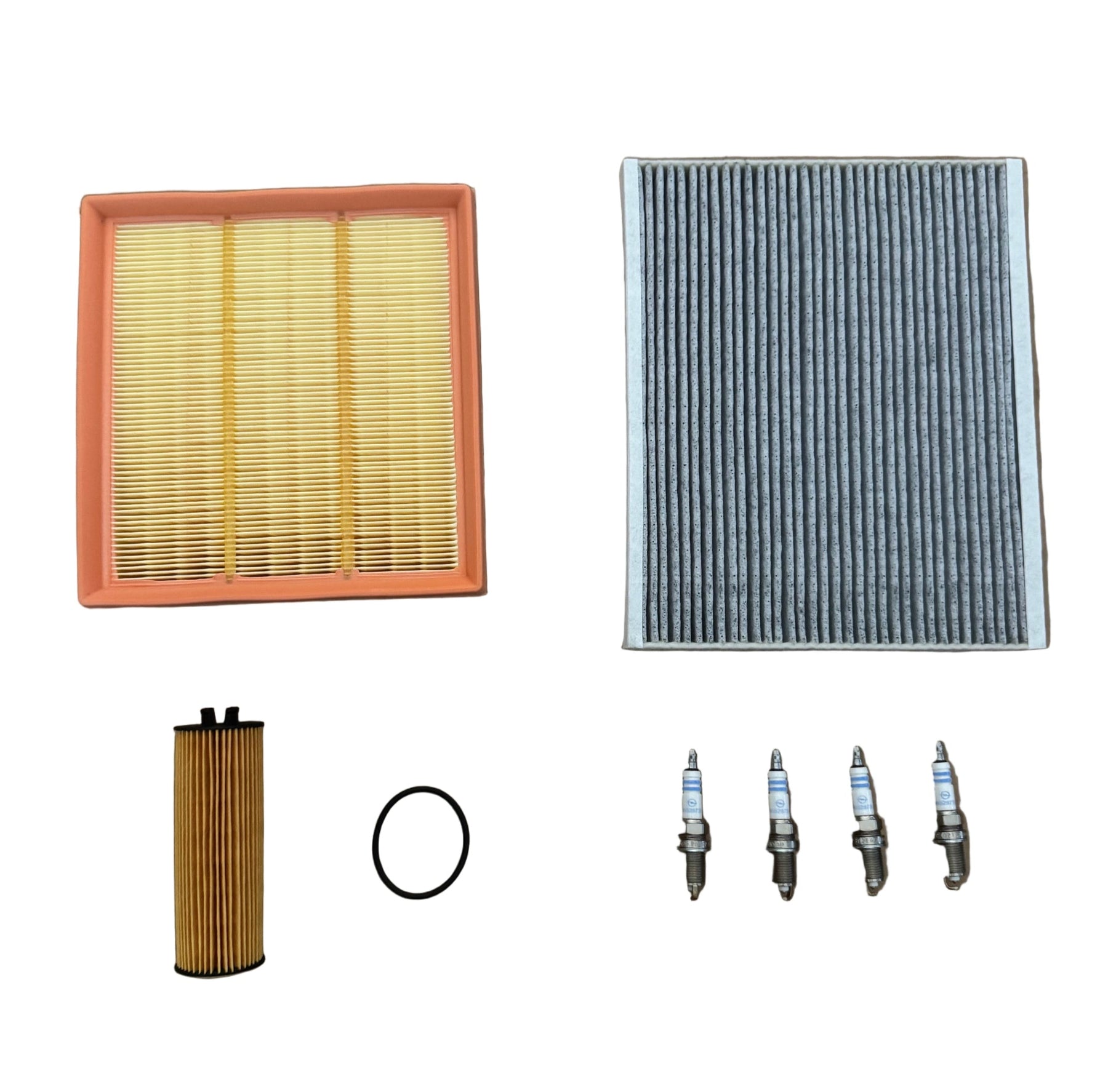 Collection of automotive filters and spark plugs on a white background